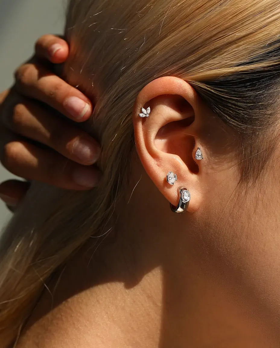 Moissanite Ørestikker i 925 Sølv - båret af en model, der stryger håret om bag øret